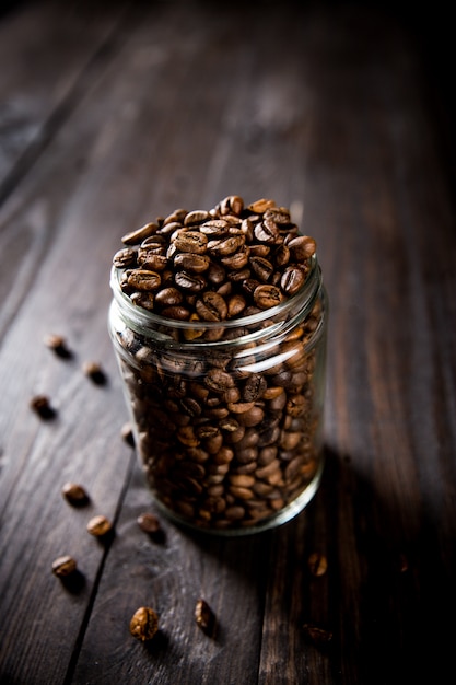 Closeup view of roasted coffee beans in glass jar