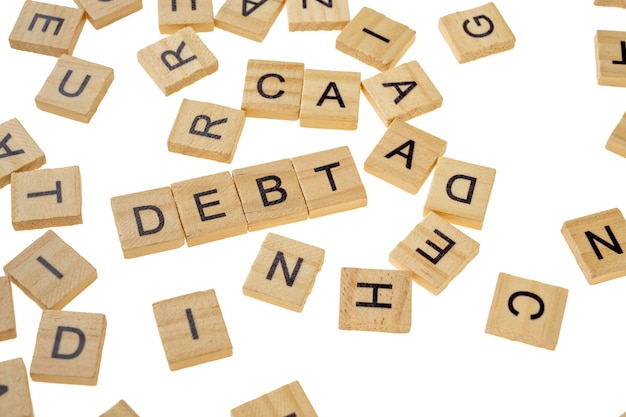 Photo closeup view row of wooden cubes with debt letters