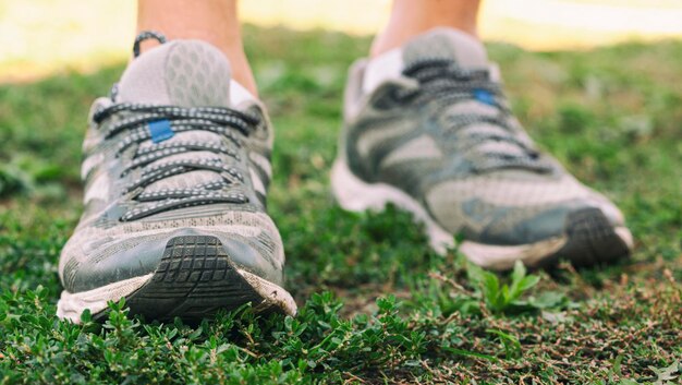 Closeup view of runners shoes running throug the\
countryside