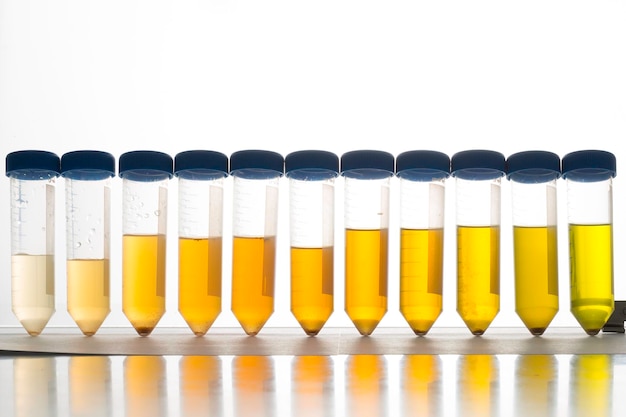 A closeup view of scientific tubes containing yellow liquid gradient of yellows during chemistry