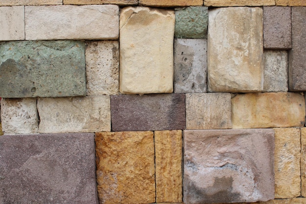 Closeup view of a wall made of several colored natural stones decor harmony vision