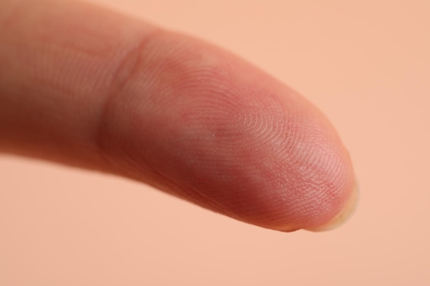 Photo closeup view of woman's finger on beige background