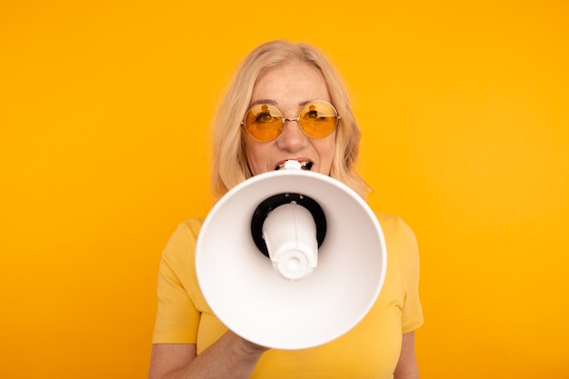 Photo closeup view of woman with loudspeaker isolated.