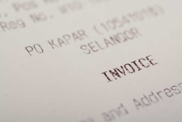 A closeup view of the word INVOICE on a sales receipt