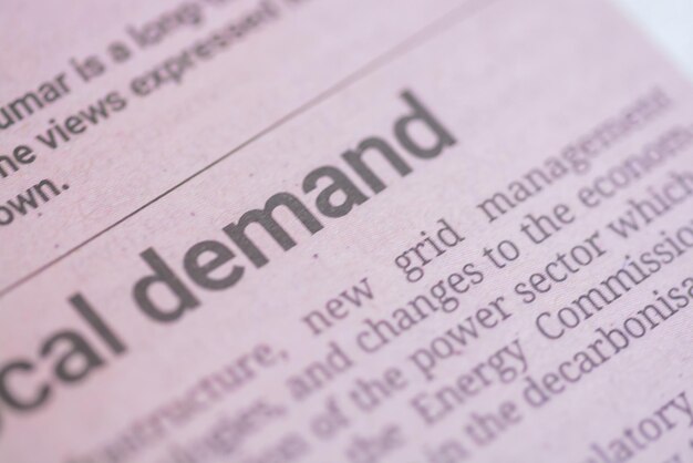 A closeup view of the wording Demand prominently displayed on a newspaper