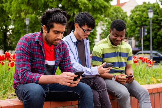 Closeup view young men looking at the smartphones