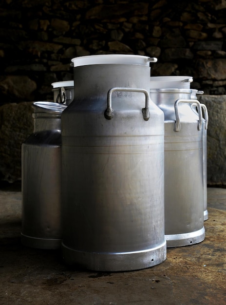 Closeup on vintage metal milk cans in a farm agriculture concept