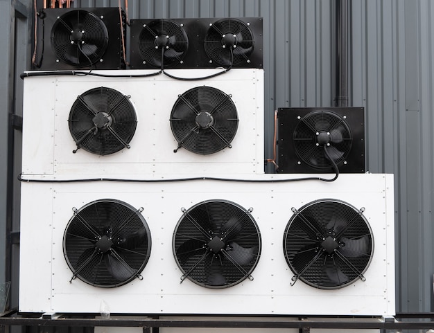 Photo closeup of wall filled with rows of industrial air conditioner unit hvac climate control system