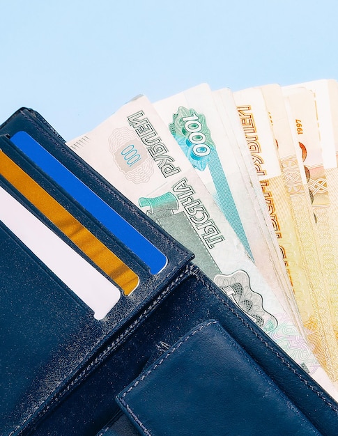 A closeup of a wallet containing bank cards and cash russian money rubles