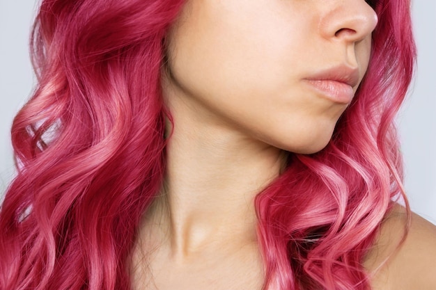 Closeup of wavy hot pink hair of a young woman isolated on a white background Result of coloring