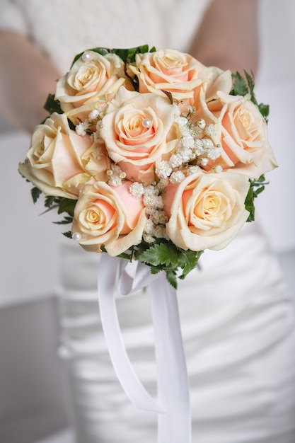 Closeup wedding bouquet with bride on backround