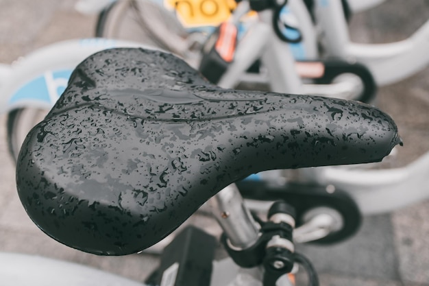 Closeup of a wet bicycle seat after rain of bike