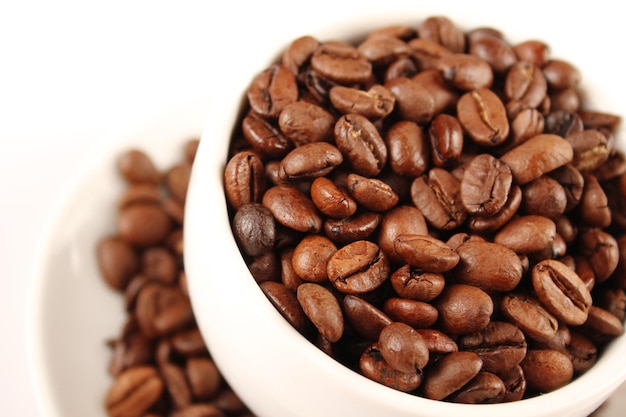 Closeup of white cup of coffee beans