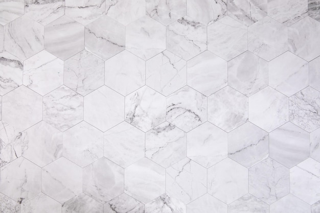 Photo closeup of the white marble wall with hexagon tiles for texture and background