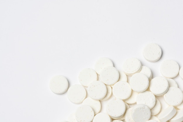 Closeup white medicine pills on white background