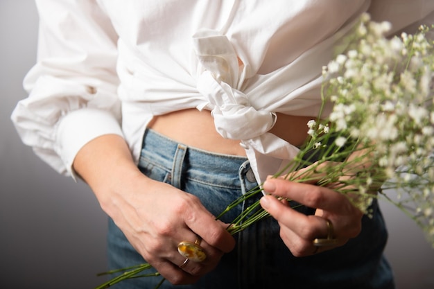 Closeup of a white shirt knot on a beautiful womans body