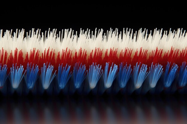 Photo closeup of white toothbrush bristles with blue and red bristle tips