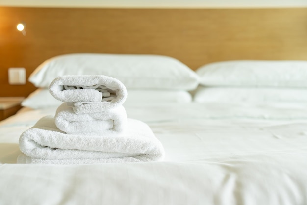 Closeup white towel on bed