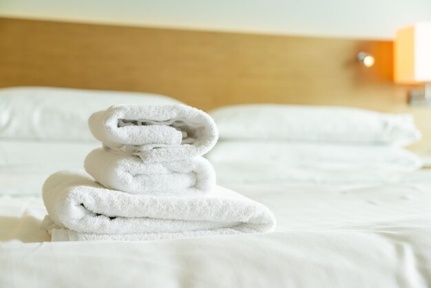 Closeup white towel on bed