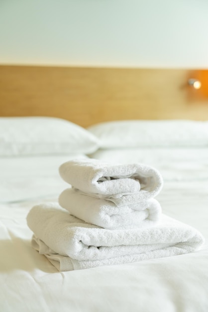 Closeup white towel on bed