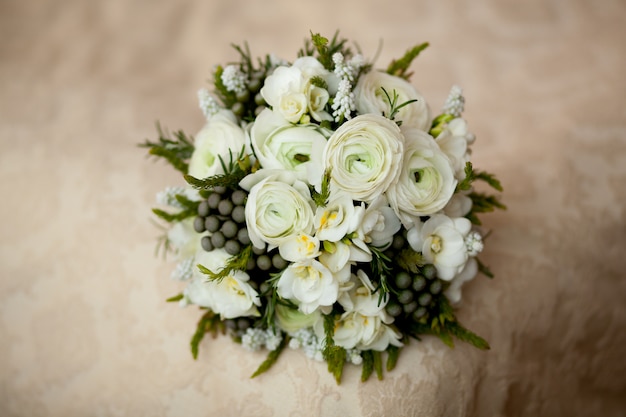 Closeup of White wedding bouquet lying on blanket
