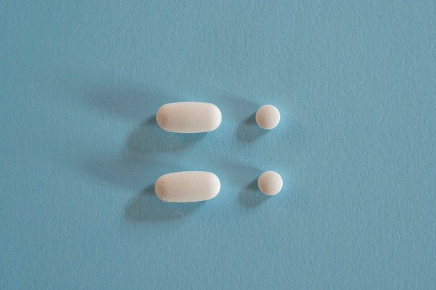 Closeup of with pills on blue background