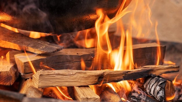 Photo closeup with the pot preparing food outdoors preparation of food on the fire