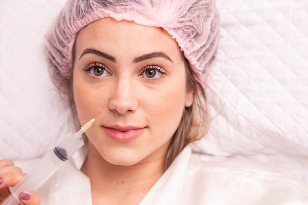 Closeup of woman applying ozone to her face for cosmetic treatment.