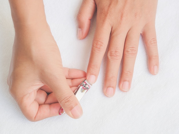 Closeup of a woman cutting nails, health care concept. 