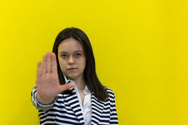 Closeup of a woman extending her hand with a serious stop gesture