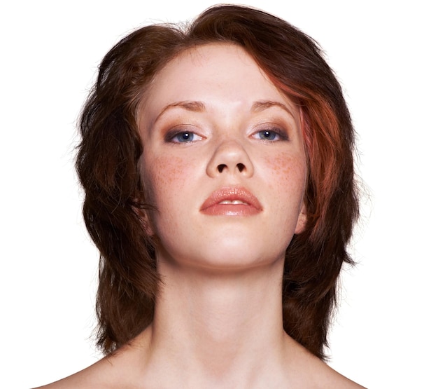 Closeup woman and face with makeup in studio white background and lipgloss in soft eyeshadow mascara and confidence Portrait skin and routine with redhead in cosmetics for beauty and wellness