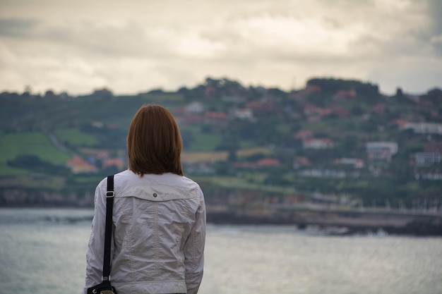 Closeup of a woman from behind looking at the buildings