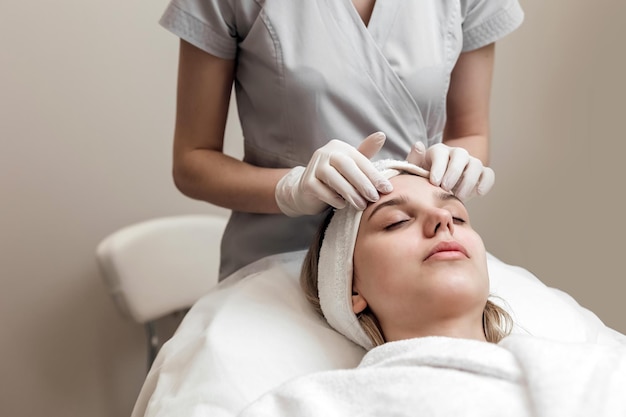 Closeup of woman getting peeling treatment at cosmetic beauty salon