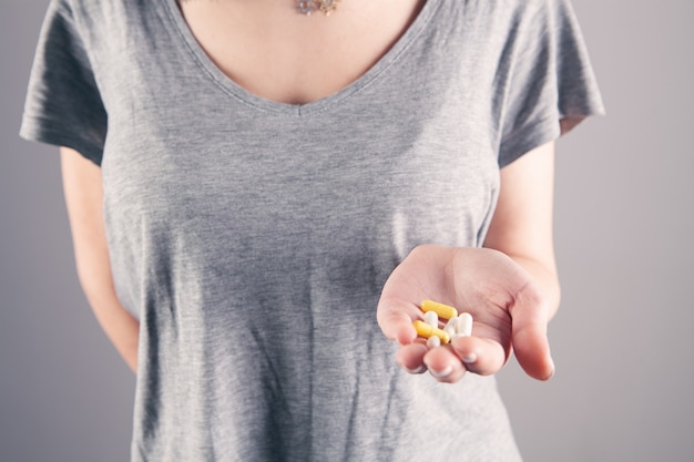 Closeup woman hand holding pills