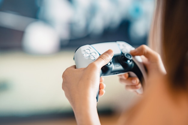 Closeup woman hand playing a computer games with joystick