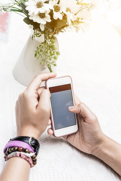 Closeup woman hand typing on smart phone