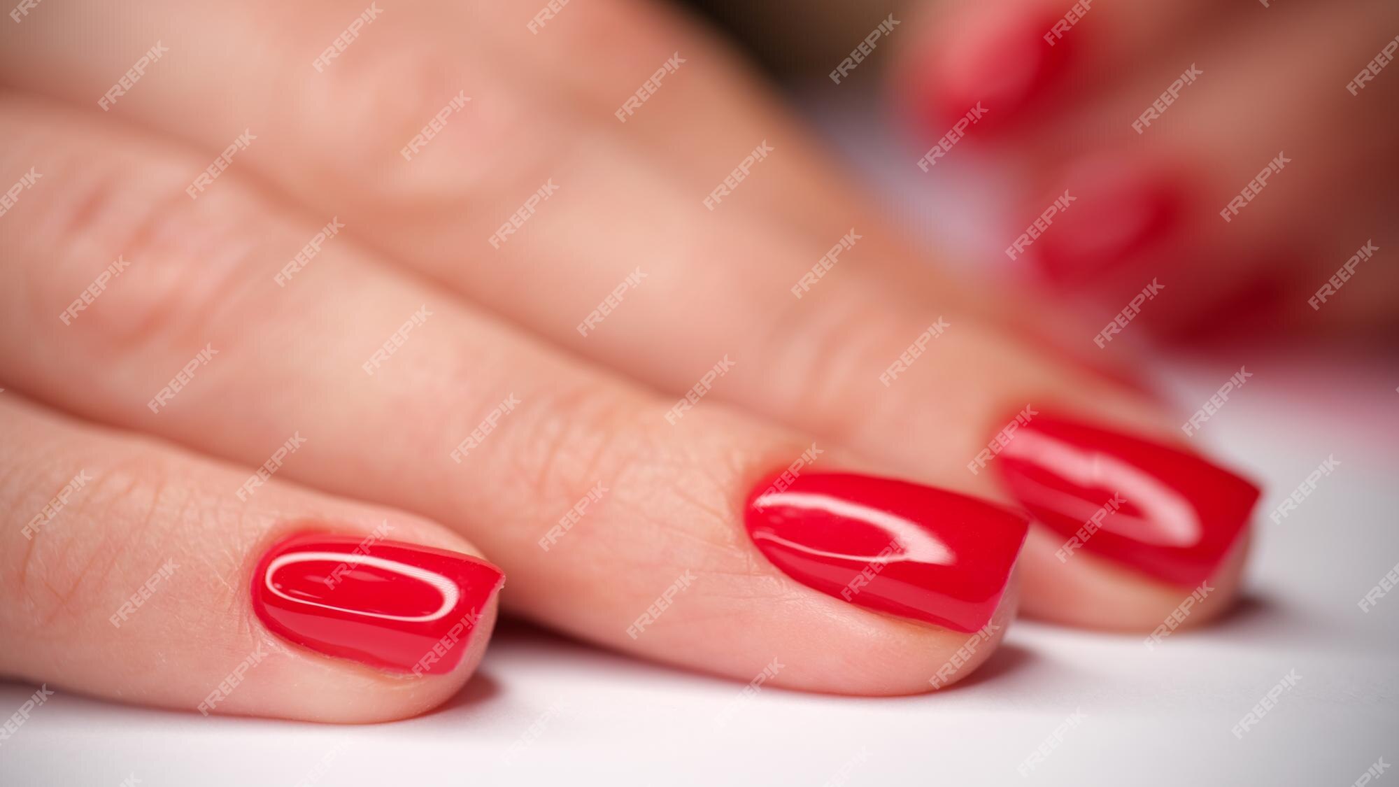 Premium Photo | Closeup of woman hand with stylish red shiny and smooth  manicure beautiful female fingernails