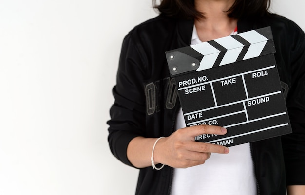 Closeup woman hands holding film clapper