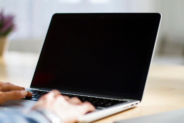 Closeup of woman hands typing on a laptop working concept