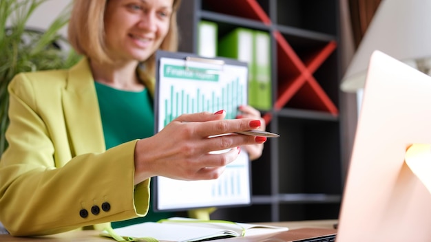 Closeup of woman having online business meeting in modern office businesswoman communicating