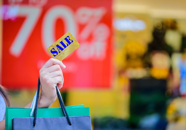 Closeup woman holding credit card and shopping bags, Black Friday sale concept