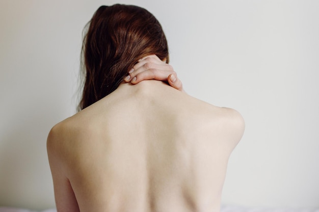 Closeup woman neck and shoulder pain and injury health care and\
medical concept