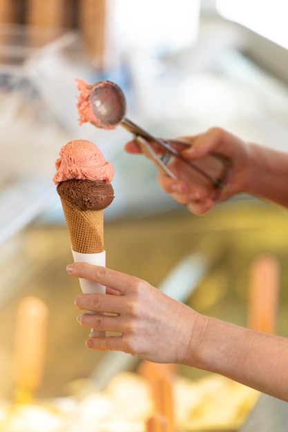 Closeup of a woman preparing and ice cream with two flavors