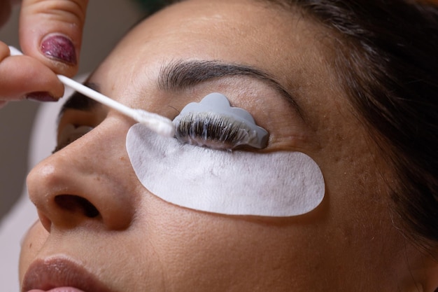 Photo closeup of a woman's face during an eyelash and eyebrow treatment