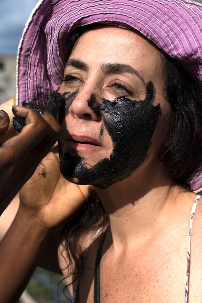 Closeup of a woman\'s face made up with black paint