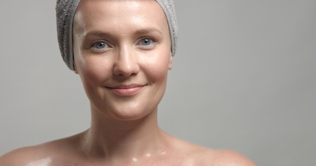 Closeup of woman's face with wet skin with drops of water on it Mousturizing skin concept