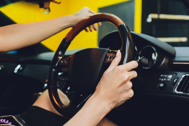 Foto close-up della mano di una donna che tiene il volante