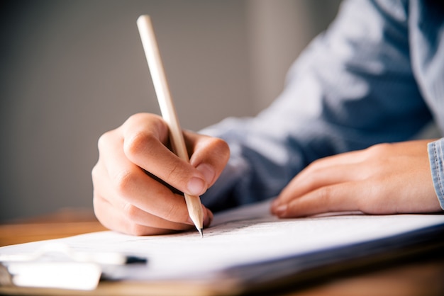 Closeup of woman's hand writing on paper