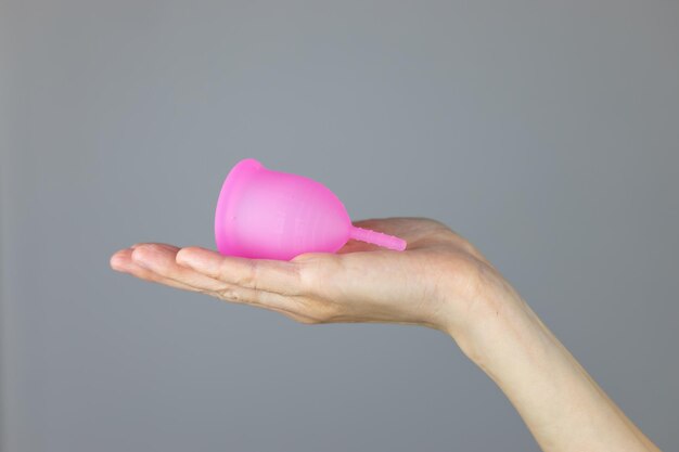 Premium Photo Closeup of a womans hands holding a silicone menstrual cup alternative ecological feminine hygiene product during menstruation wastefree concept