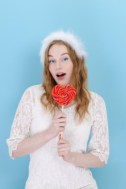 Closeup of woman's holding a heart lolipop in front of her